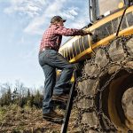 farmer climbing tractor